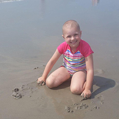 A little girl on a respite at the beach sponsored by A Week Away.