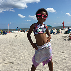 A little girl on a respite at the beach sponsored by A Week Away.