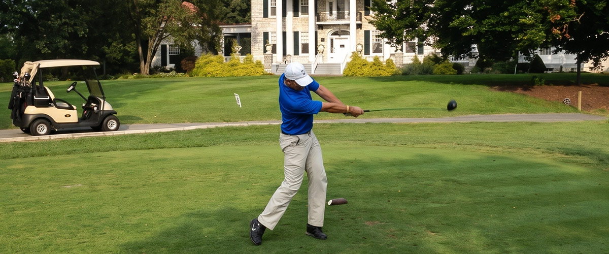 Caleb Walker golfing at the first Golf Tournament.